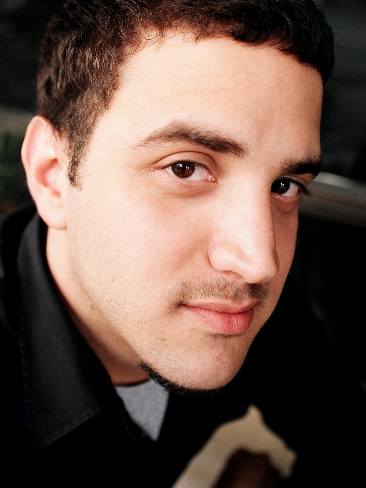 Eli Korwin in profile, dark backdrop, the look of someone listening hard.