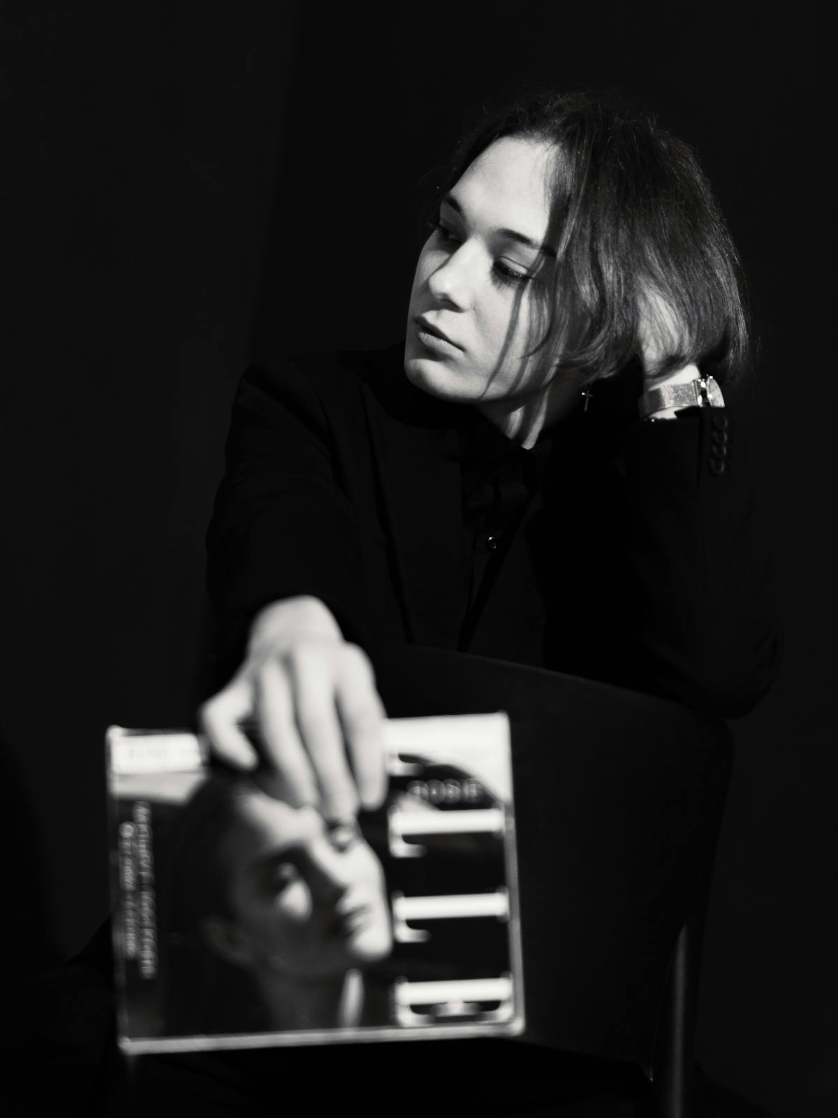 Maya, second portrait — magazine in hand, studio light.